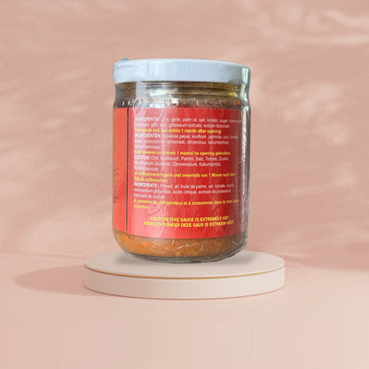 Sambal Geprek Nesia, extra scharf, mit roten Chili und Knoblauch, in einer Schüssel auf einem weißen Hintergrund.